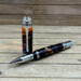 Large rollerball pen with orange, black, and purple epoxy